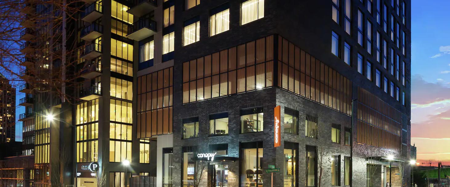 Nighttime exterior photo of Hilton Canopy building, Atlanta Midtown